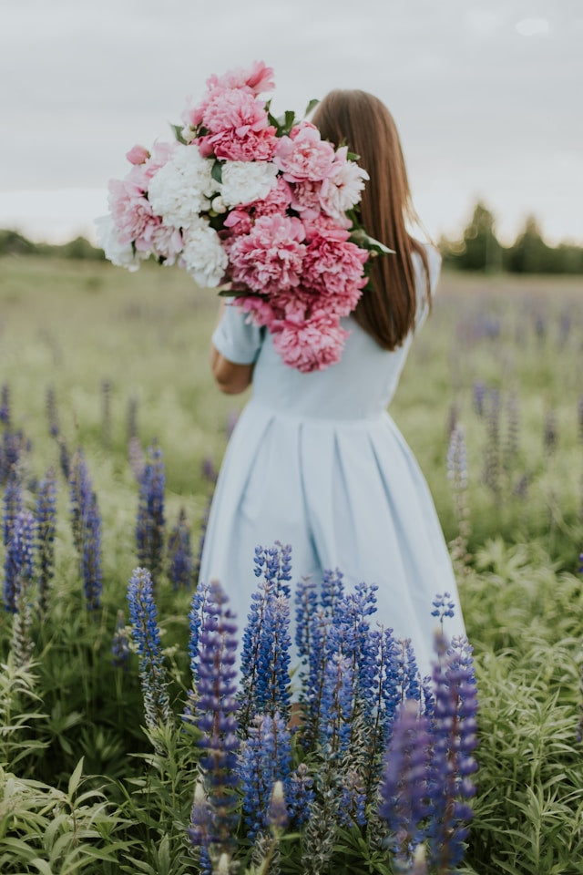 woman in nature with flowers